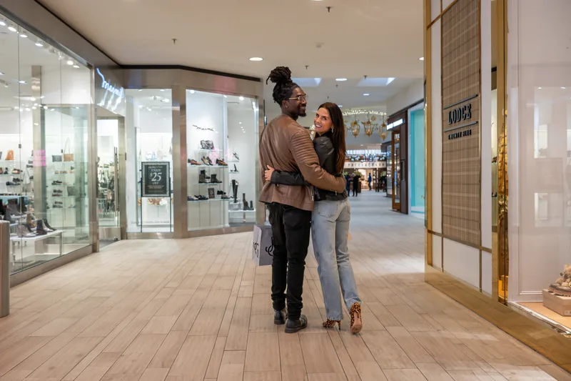 A couple shopping together in an upscale corridor at The Galleria Edina